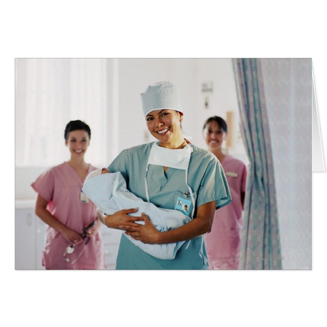 Delivery room nurse holding baby, nurses in (Front Horizontal)