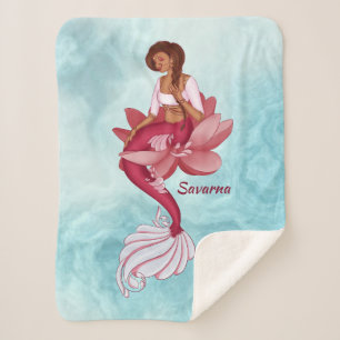 Desi pink mermaid sitting in a pink lotus flower sherpa blanket