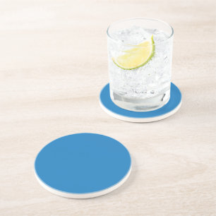 Dessous De Verre En Grès un arrière - plan bleu avec une horloge noire et b