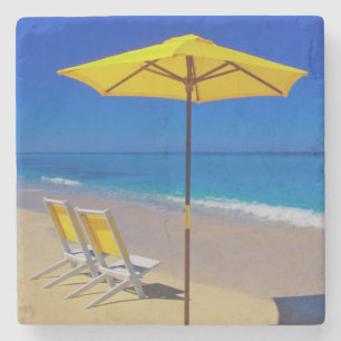 Dessous-de-verre En Pierre Parapluie de plage jaune et chaises sur une plage