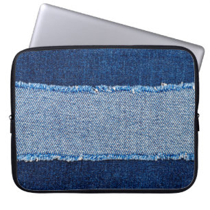 Destroyed torn denim blue jeans fabric frame on bl laptop sleeve