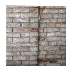 Detail of a wall of an old red brick with white co tile