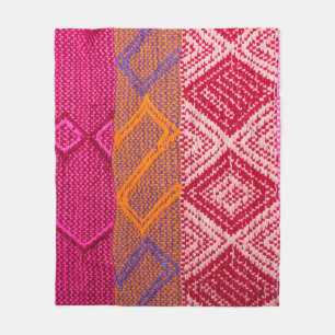 Details shot of indian fabric with colourful patte fleece blanket
