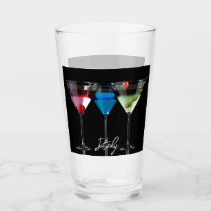 Different cocktails in martini glasses on black