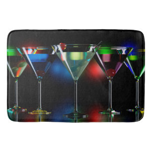 Different cocktails in martini glasses with lights bath mat