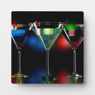 Different cocktails in martini glasses with lights plaque