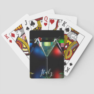 Different cocktails in martini glasses with lights playing cards