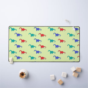 Dinosaures colorés motif sur vert