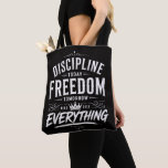 Discipline Today Freedom Tomorrow Tote Bag<br><div class="desc">A bold and powerful typography design set on a deep black background with distressed white lettering. This eye-catching composition combines vintage and street-style elements, featuring layered fonts, ornamental details, and a strong motivational message. The mix of classic serif typography and rough brush-style text creates a dynamic and modern look that...</div>