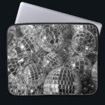 Disco Ball Ornaments Laptop Sleeve<br><div class="desc">Disco ball ornaments of various sizes form a chaotic pile in this unique black and white photograph. The shiny mirror balls reflect bright light or dark shadows from each of their small mirrored facets. The glitter ball ornaments rest on top of garlands with reflective silver dodecahedron beads. Digital, black &...</div>