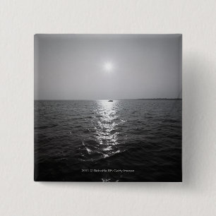 Distant boat on ocean 2 inch square button
