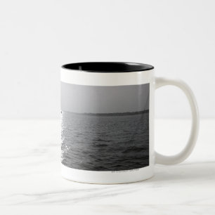 Distant boat on ocean Two-Tone coffee mug