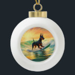 Doberman Beach Surfing Painting Ceramic Ball Christmas Ornament<br><div class="desc">Immerse yourself in the playful world of canine adventure with this captivating painting. A spirited dog takes to the waves, skilfully riding the surf on a sun-kissed beach. The vibrant artwork beautifully captures the essence of beachside excitement as the dog fearlessly rides the waves, embodying the spirit of fun and...</div>