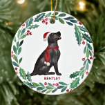 Dog Christmas Personalized Pet Black Labrador  Ceramic Ornament<br><div class="desc">Decorate your tree or give a special gift this holiday season with this elegant Merry Christmas black labrador retriever in a wreath design christmas ornament, and matching decor. This black labrador christmas ornament features a watercolor dog in a green and red wreath with holly and berries. Personalize with name front,...</div>