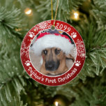 Dog First Christmas Snowflakes 2 Photo Red Ceramic Ornament<br><div class="desc">Create a personalized photo keepsake ornament for a puppy or dog with this festive red and white round ceramic ornament featuring 2 pictures (one on each side), dog pawprints and snowflakes with your custom text (the sample shows Name's First Christmas). The design is duplicated on both sides with the same...</div>