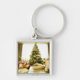 dog posing in front of Christmas tree Keychain