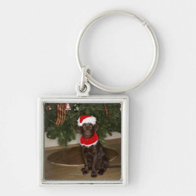 Dog sitting by a Christmas tree Keychain (Front)