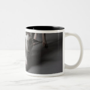 Dog with diva bowl, sniffing floor Two-Tone coffee mug