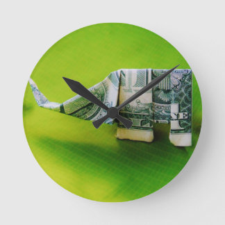 Dollar bill origami Elephant on Green background Round Clock