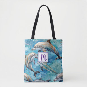 Dolphins swimming in the sea tote bag