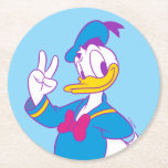 Donald Duck Peace Sign Round Paper Coaster<br><div class="desc">Brighten up your wardrobe with this electric and cheerful Donald Duck illustration! Featuring a classic full-body pose with a friendly peace sign, this design gets a stylish update with a vibrant, non-traditional color palette. The combination of bright cyan, magenta, and sunny yellow gives this artwork a fresh, "neon-pop" aesthetic that...</div>