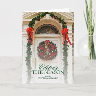 Door with wreath and Christmas decorations. Holiday Card