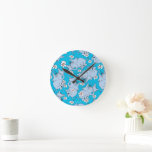 Dr. Seuss Horton Hears a Who Round Clock<br><div class="desc">This pattern design features characters from the classic Dr. Seuss story, Horton Hears a Who!. Multiple illustrations of Horton the elephant are scattered across a solid cyan blue background. He is depicted alongside numerous white and pink daisies. The style utilizes the signature sketchy, hand-drawn lines associated with Dr. Seuss illustrations....</div>
