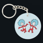 Dr. Seuss Thing 1 and Thing 2 Character Keychain<br><div class="desc">This officially licensed Dr. Seuss product features a classic, vibrant illustration of the mischievous duo, Thing 1 and Thing 2, from the iconic book The Cat in the Hat. The design showcases the lively pair mid-dance, complete with their signature wild blue hair, bright red jumpsuits, and circular name emblems on...</div>