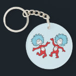 Dr. Seuss Thing 1 and Thing 2 Character Keychain<br><div class="desc">This officially licensed Dr. Seuss product features a classic, vibrant illustration of the mischievous duo, Thing 1 and Thing 2, from the iconic book The Cat in the Hat. The design showcases the lively pair mid-dance, complete with their signature wild blue hair, bright red jumpsuits, and circular name emblems on...</div>