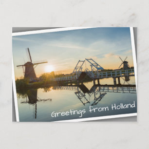 Drawbridge and windmills at sunset in Holland Postcard