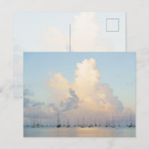 Dreamy pastel sunrise over bay and sailing boats