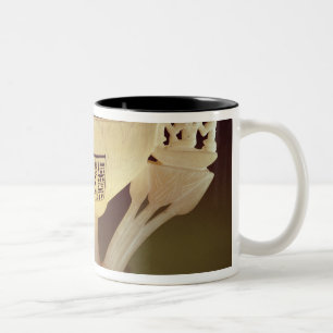 Drinking cup in the form of a half-opened