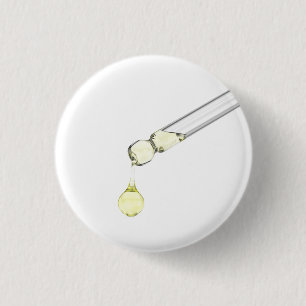 Dripping yellow serum from a pipette 1 inch round button