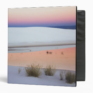 Dusk sky reflected in pool of water from binder