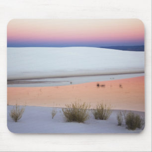 Dusk sky reflected in pool of water from mouse pad