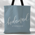 Dusty Blue Bridesmaid Modern Script Tote Bag<br><div class="desc">Show your appreciation to your bridal party with this stylish dusty blue bridesmaid tote bag. Featuring modern script and customizable with your bridesmaid's name, this tote bag is both practical and elegant. The soft colour and chic design make it perfect for carrying wedding day essentials or everyday items. This personalized...</div>