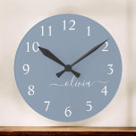 Dusty Blue Modern Script Elegant Monogram Name Round Clock<br><div class="desc">Introducing our Dusty Blue Minimalist Modern Monogram Elegant Collection: Elevate your style with understated sophistication and timeless charm. Our collection features minimalist designs in a soothing dusty blue hue, enhanced with elegant monograms tailored to your personal taste. From refined stationery to versatile accessories, each piece in our collection is meticulously...</div>