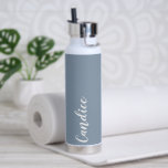 Dusty Blue Personalized Wedding Bridesmaid Water Bottle<br><div class="desc">Gift your wedding bridesmaid or maid of honour with this trendy, vacuum Insulated water bottle that features her name in white, stylized script on a dusty blue colour background designed to match your wedding colour scheme. Personalize bottle by editing and replacing name with your own as desired. Select your water...</div>