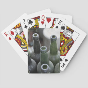 Dusty green glass bottles playing cards