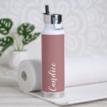 Dusty Rose Personalized Wedding Bridesmaid Water Bottle<br><div class="desc">Gift your wedding bridesmaid or maid of honour with this trendy, vacuum Insulated water bottle that features her name in white, stylized script on a dusty rose colour background designed to match your wedding colour scheme. Personalize bottle by editing and replacing name with your own as desired. Select your water...</div>