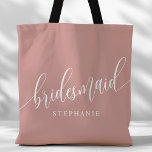 Dusty Rose Pink Bridesmaid Modern Script Tote Bag<br><div class="desc">Show your appreciation to your bridal party with this stylish dusty rose pink bridesmaid tote bag. Featuring modern script and customizable with your bridesmaid's name, this tote bag is both practical and elegant. The soft colour and chic design make it perfect for carrying wedding day essentials or everyday items. This...</div>