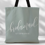 Dusty Sage Bridesmaid Modern Script Tote Bag<br><div class="desc">Show your appreciation to your bridal party with this stylish dusty sage green bridesmaid tote bag. Featuring modern script and customizable with your bridesmaid's name, this tote bag is both practical and elegant. The soft colour and chic design make it perfect for carrying wedding day essentials or everyday items. This...</div>