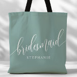 Dusty Teal Bridesmaid Modern Script Tote Bag<br><div class="desc">Show your appreciation to your bridal party with this stylish dusty teal bridesmaid tote bag. Featuring modern script and customizable with your bridesmaid's name, this tote bag is both practical and elegant. The soft colour and chic design make it perfect for carrying wedding day essentials or everyday items. This personalized...</div>