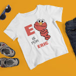 E is for Elmo | Add Your Name T-Shirt<br><div class="desc">This design features Elmo from Sesame Street in a vibrant and playful illustration. The letter "E" is prominently displayed, symbolizing the start of Elmo's name, with Elmo happily peeking out, spreading joy and energy. The design also includes customizable text, allowing you to add a name, making it a fun and...</div>