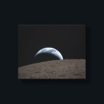Earthset Orion Spacecraft Artemis Moon Mission Canvas Print<br><div class="desc">Earthset captured through the Orion spacecraft window at 6:41 p.m. EDT, April 6, 2026, during the Artemis II crew’s flyby of the Moon. A muted blue Earth with bright white clouds sets behind the cratered lunar surface. The dark portion of Earth is experiencing nighttime. On Earth’s day side, swirling clouds...</div>