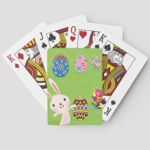 Easter bunny playful with painted eggs playing cards