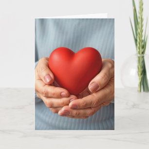 Elderly Woman Holding a Red Heart Card