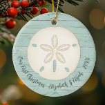 Elegant Beach Sand Dollar Photo First Christmas Ceramic Ornament<br><div class="desc">A joyful Christmas ornament with a sand dollar and a weathered wood background for your 1st Christmas Celebration. Great for newlyweds. Put a beach honeymoon photo on the back. Personalize the front with your names and the year. Designed for you by Blackberry Boulevard.</div>