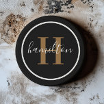 Elegant Black Brown Round Monogram Dark Coaster<br><div class="desc">An elegant sandstone coaster featuring a warm cognac tan brown serif initial and custom family name in script, framed by a circle on a rich black background. The warm cognac-toned typography against dark stone creates a distinguished, leather-inspired aesthetic. A sophisticated personalized gift for groomsmen, housewarmings, or milestone celebrations. All text...</div>