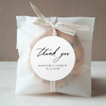 Elegant Black Calligraphy Wedding Thank You Classic Round Sticker<br><div class="desc">Elegant wedding thank you stickers featuring "thank you" displayed in modern black calligraphy with a white background. Personalize the black and white wedding thank you stickers with your names and wedding date. The chic wedding thank you stickers are perfect for sealing envelopes, wedding favour bags, and more. Designed to coordinate...</div>